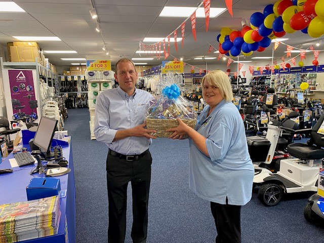 Ableworld Burton presenting hamper prize to their lucky winner for their store opening competition